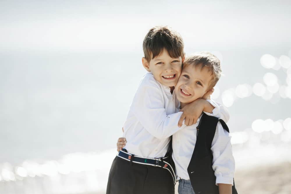 Two young siblings laughing and playing together