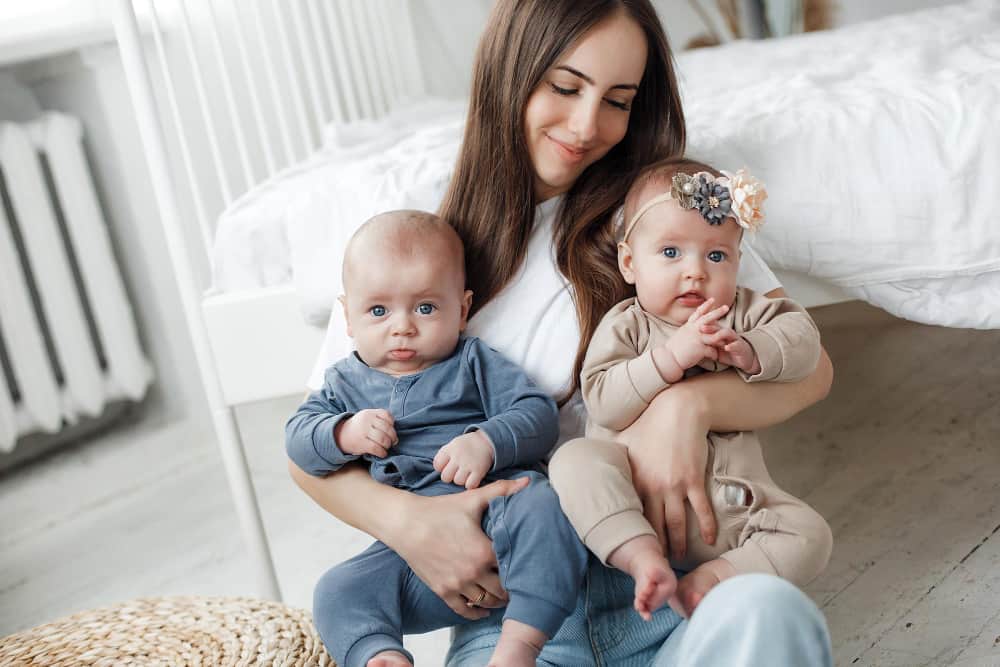 Two baby name tags with coordinated fonts symbolizing siblings