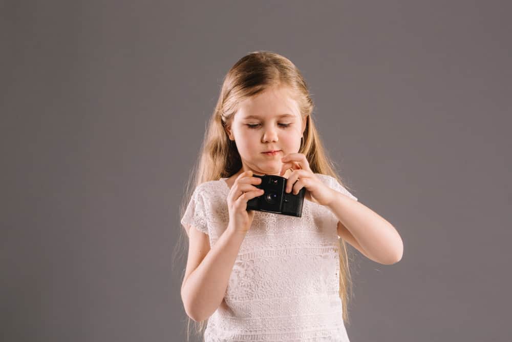 Parent teaching child about saving money with coins and a piggy bank