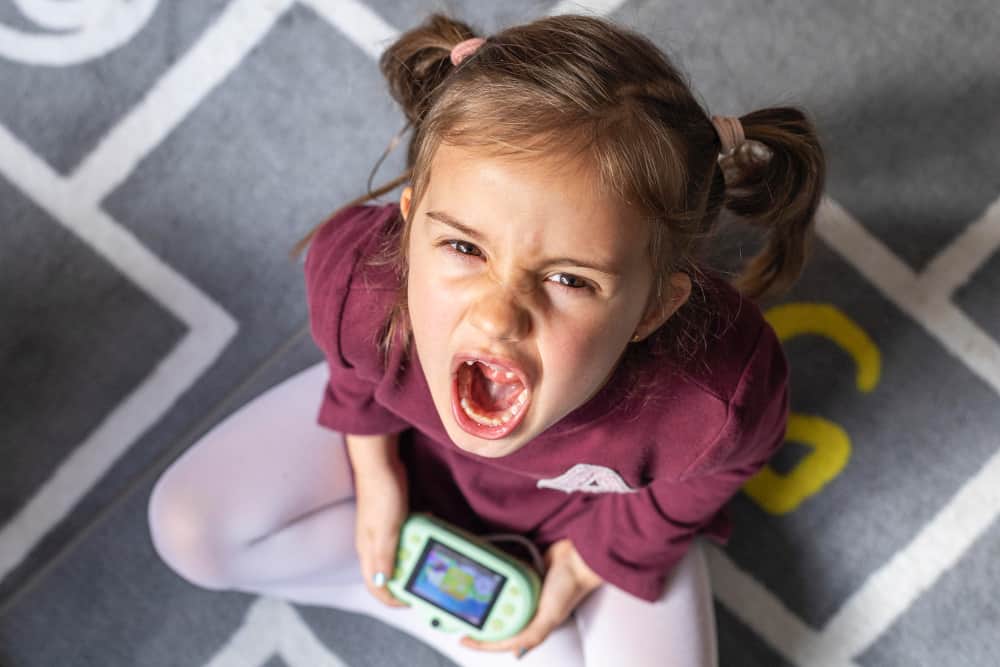 Toddler crossing arms and saying no during a conversation with a parent